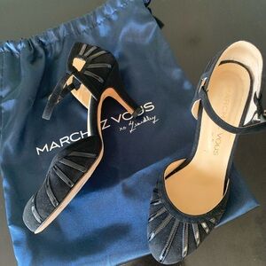 Timeless and elegant black suede heels with patent leather detail.